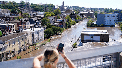 girl taking photo of flooding