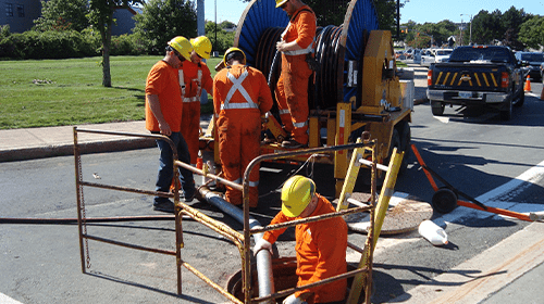 workers repairing sewer damage