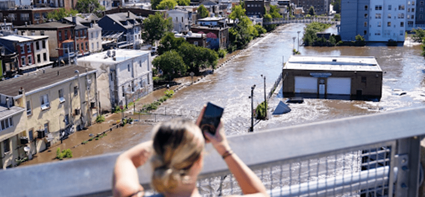 Girl taking photo of storm damage
